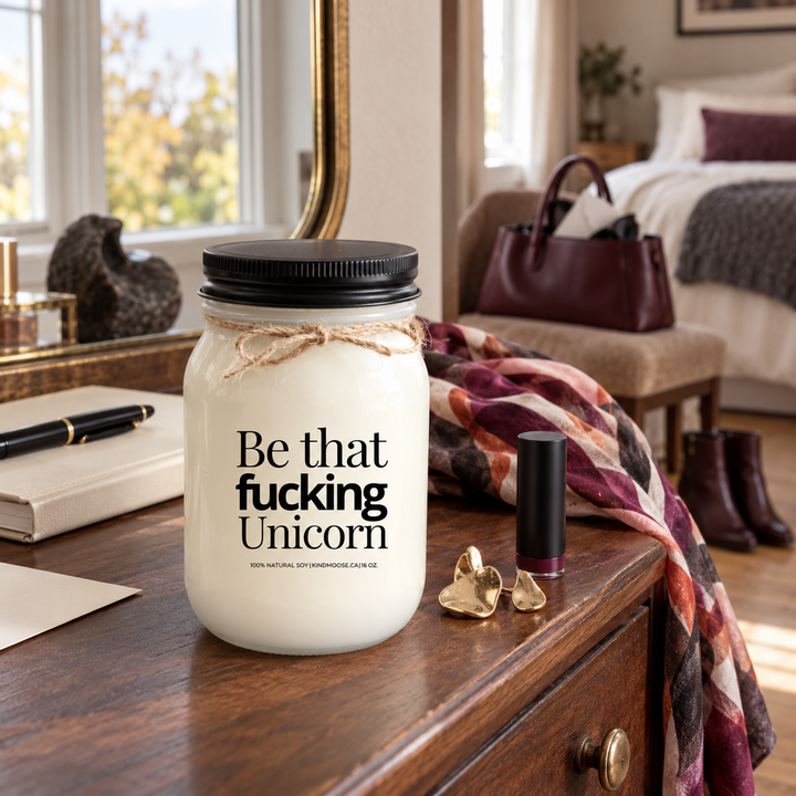Be That Fucking Unicorn KINDMOOSE candle with black lid in a sophisticated bedroom dressing area with bold personal accessories.