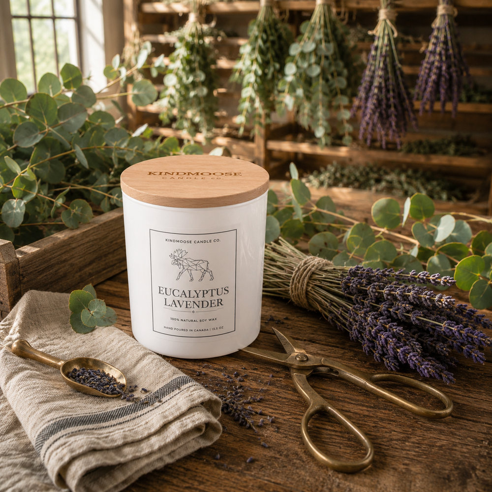 Eucalyptus Lavender Double Wick soy candle with a natural wood lid displayed on a rustic botanical worktable surrounded by fresh eucalyptus, lavender bundles, antique brass shears and a sunlit herbal drying loft.