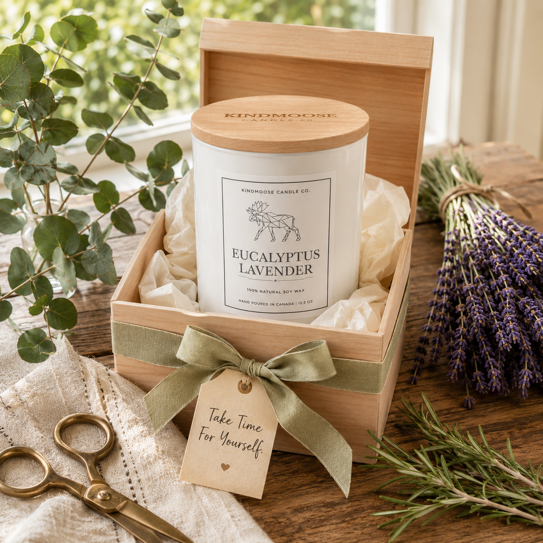 Eucalyptus Lavender Double Wick soy candle with a black wooden lid displayed beside fresh lavender, eucalyptus and a thoughtfully wrapped gift in a bright, welcoming home filled with natural morning light.