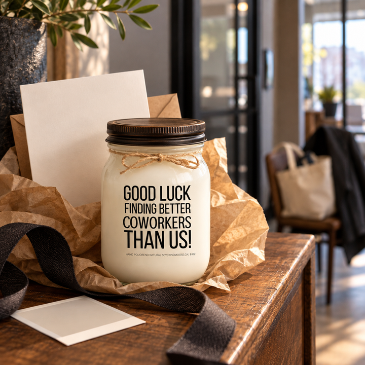 KINDMOOSE Good Luck Finding Better Coworkers Than Us candle with distressed bronze lid presented as a coworker farewell gift with a card and kraft wrapping.