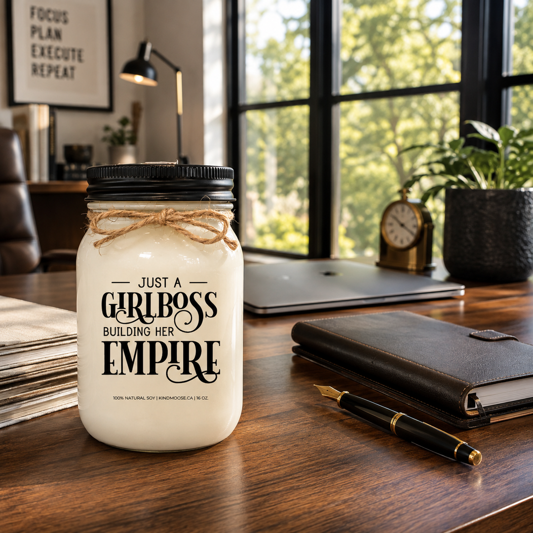 KINDMOOSE Just A Girlboss Building Her Empire frosted soy candle with a matte black lid displayed on a luxury executive desk in a bright modern farmhouse office.
