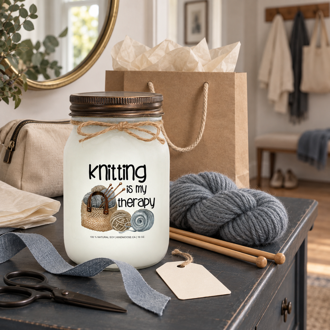 KINDMOOSE Knitting Is My Therapy candle styled with yarn, knitting needles and gift packaging as a thoughtful gift for a knitter.