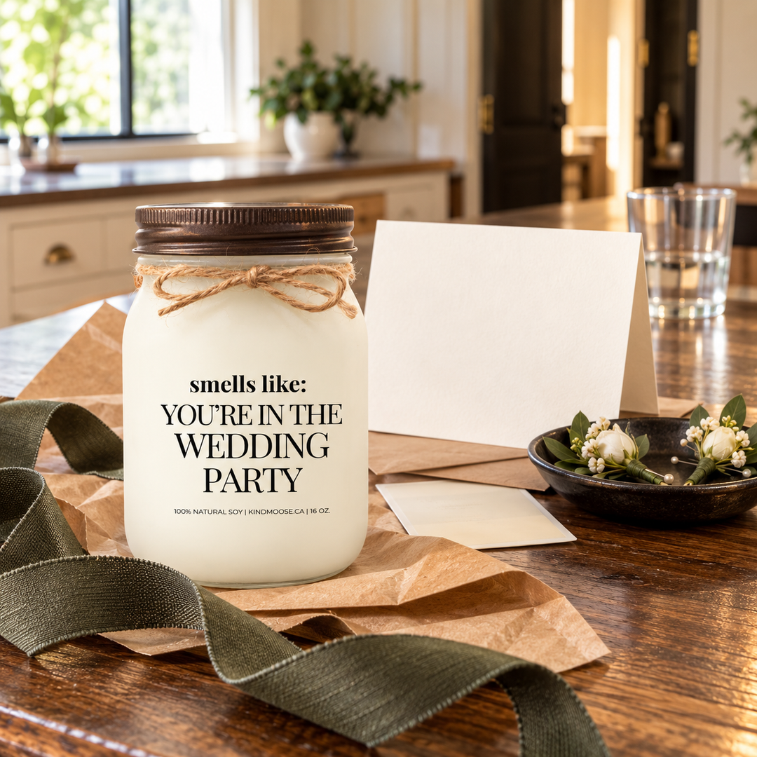 KINDMOOSE Smells Like You're in the Wedding Party candle presented with a blank card, kraft paper and ribbon as a thoughtful wedding-party proposal gift.