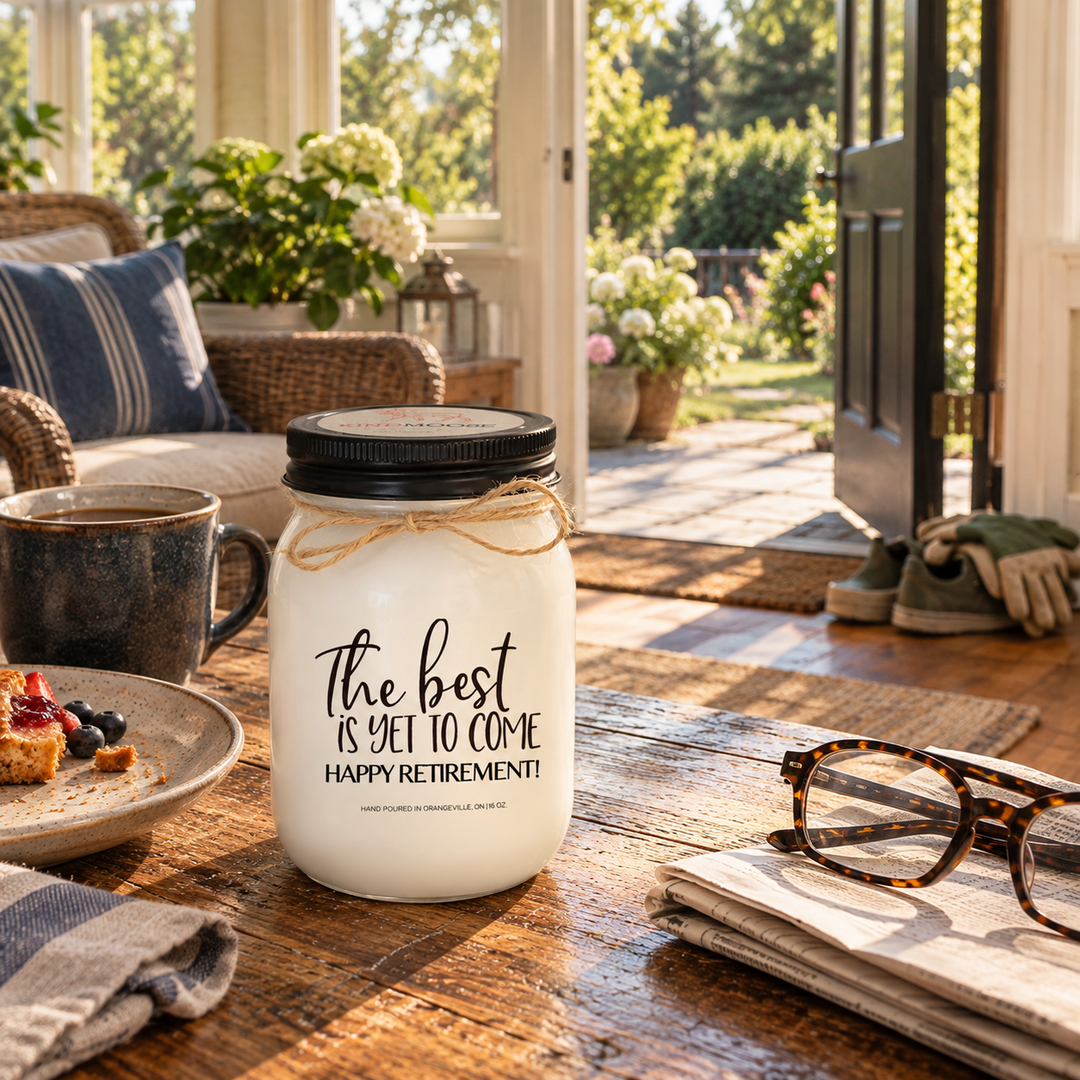 The Best Is Yet to Come Happy Retirement KINDMOOSE candle in a peaceful breakfast nook, capturing the first relaxed morning of retirement.
