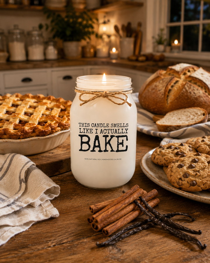 Burning THIS CANDLE SMELLS LIKE I ACTUALLY BAKE soy candle displayed in a cozy farmhouse kitchen surrounded by finished baked goods, including fresh bread, homemade pie, and warm cookies. Soft evening lighting and elegant kitchen décor create a comforting bakery-inspired atmosphere filled with warmth and nostalgia.