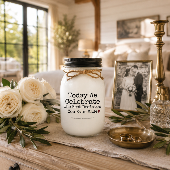 Today We Celebrate The Best Decision You Ever Made customizable 16 oz soy candle with a black lid displayed on a reclaimed white oak bedroom dresser. White garden roses, wedding bands, a crystal perfume bottle, and soft morning light create a romantic modern farmhouse anniversary scene celebrating lifelong love.