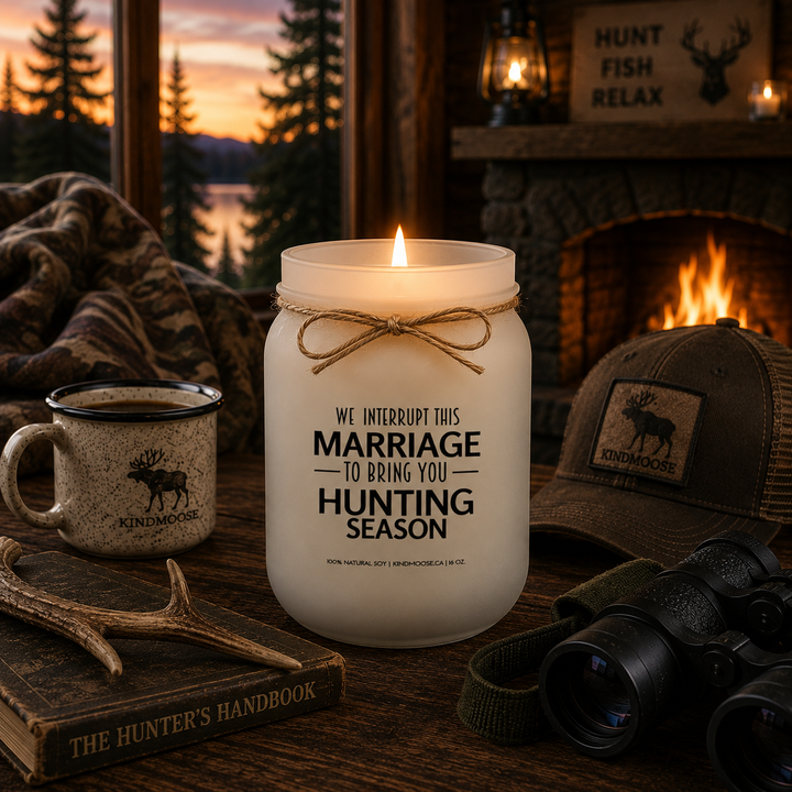 Burning WE INTERRUPT THIS MARRIAGE TO BRING YOU HUNTING SEASON soy candle inside a rustic hunting lodge featuring a stone fireplace, warm evening lighting, forest views, hunting décor, and cozy cabin furnishings. 
